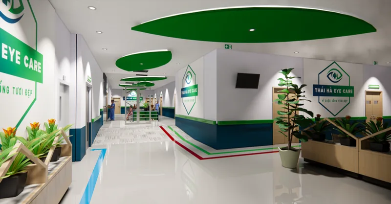 Phối cảnh hành lang lễ tân tông xanh lá trắng với logo Thái Hà Eye Care tại Bệnh viện Mắt Thái Hà.